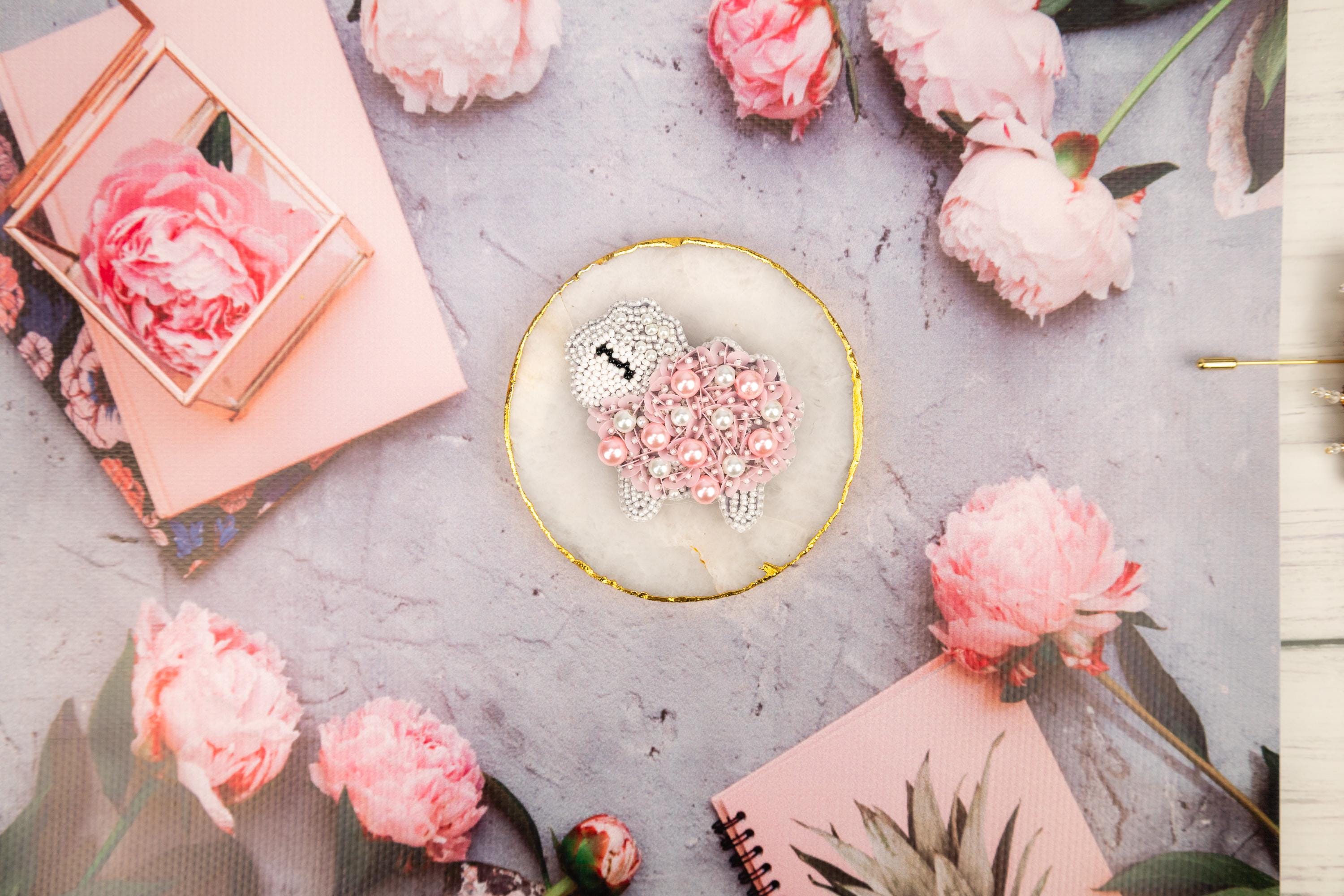 a table topped with pink flowers and a cake